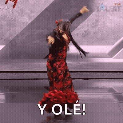 Woman In Red Dress Dancing In Front Of Yole Sign GIF
