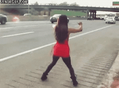 Woman In Red Dress Dancing On Highway GIF