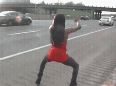 Woman In Red Dress Dancing On Highway GIF