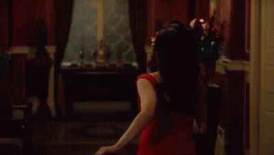 Woman In Red Dress Dancing With Falling Petals GIF