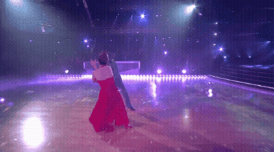 Woman In Red Dress Dancing With Man In Blue Suit GIF