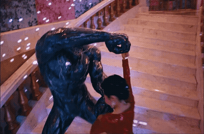 Woman In Red Dress Dancing With Statue GIF