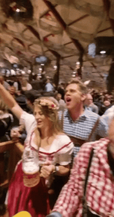 Woman In Red Dress Holding Beer While Man Shouts GIF