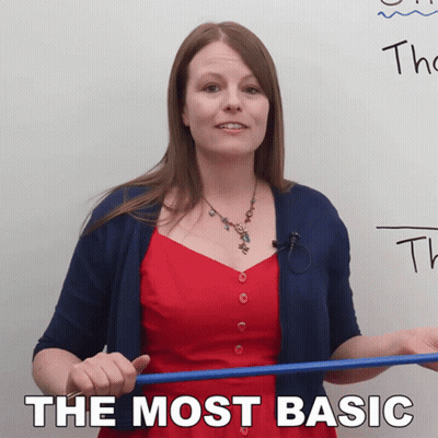 Woman In Red Dress Holding Blue Stick Before Board Saying The Most Basic GIF