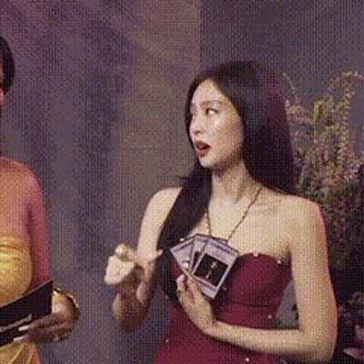 Woman In Red Dress Holding Card GIF