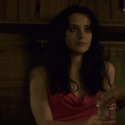 Woman In Red Dress Holding Glass Of Water GIF