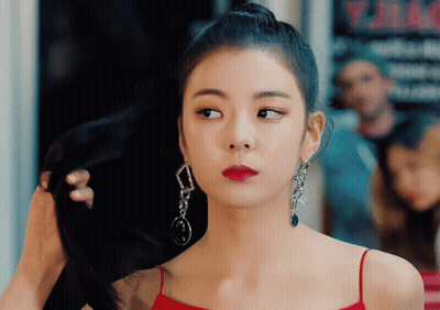 Woman In Red Dress Holding Hair Bun GIF