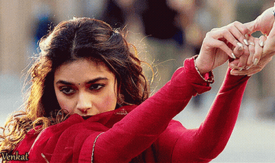 Woman in Red Dress Holding Hand Before Venkat Sign