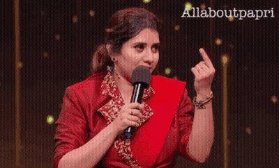 Woman In Red Dress Holding Microphone Giving Middle Finger GIF