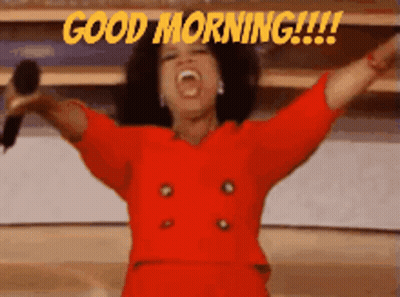 Woman In Red Dress Holding Microphone Saying Good Morning GIF