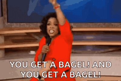 Woman In Red Dress Holding Microphone Saying You Get A Bagel GIF