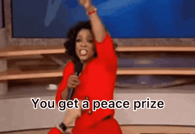 Woman In Red Dress Holding Microphone Saying You Get A Peace Prize GIF