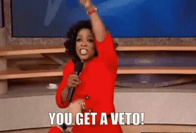 Woman In Red Dress Holding Microphone Saying You Get A Veto GIF