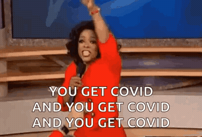 Woman in Red Dress Holding Microphone Saying You Get Covid