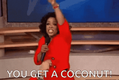 Woman In Red Dress Holding Microphone Says You Get A Coconut GIF
