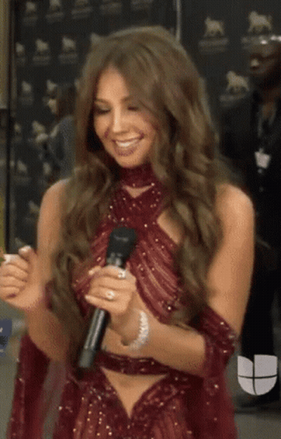 Woman In Red Dress Holding Microphone Smiling GIF