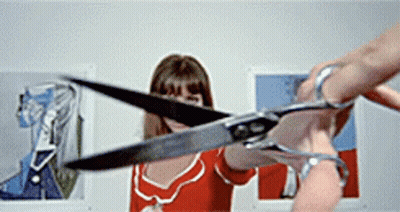 Woman In Red Dress Holding Scissors GIF