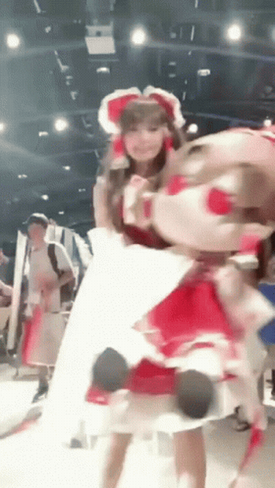 Woman In Red Dress Holding Stuffed Animal GIF
