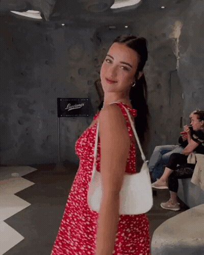 Woman In Red Dress Holding White Bag GIF