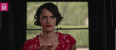 Woman In Red Dress Holding Wine And Making Face GIF