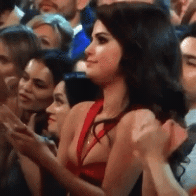 Woman In Red Dress In Clapping Crowd GIF