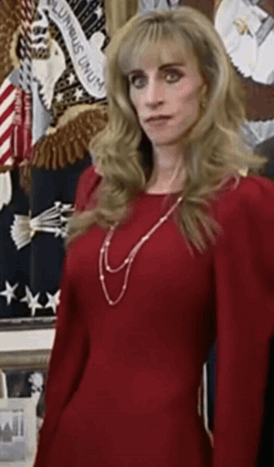 Woman In Red Dress In Front Of American Flag GIF