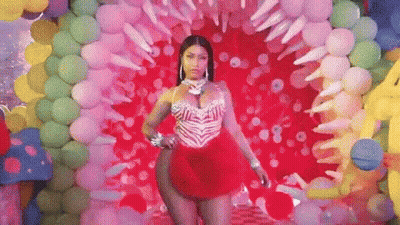 Woman In Red Dress In Front Of Balloons GIF