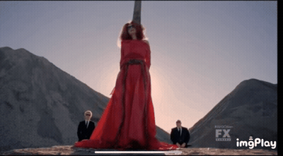 Woman In Red Dress In Front Of Cross With FX GIF
