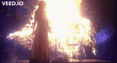 Woman In Red Dress In Front Of Fire GIF