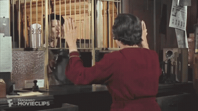 Woman In Red Dress In Front Of Movieclips Cage GIF