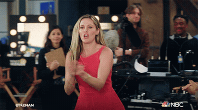 Woman In Red Dress In Front Of NBC Sign GIF