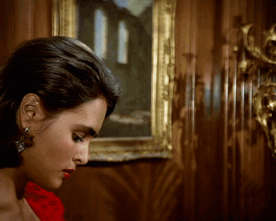 Woman In Red Dress In Front Of Painting GIF