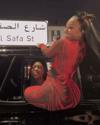 Woman In Red Dress In Front Of Safa St Sign GIF