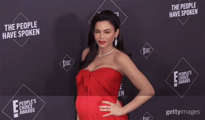 Woman In Red Dress In Front Of Wall Saying The People Have Spoken GIF