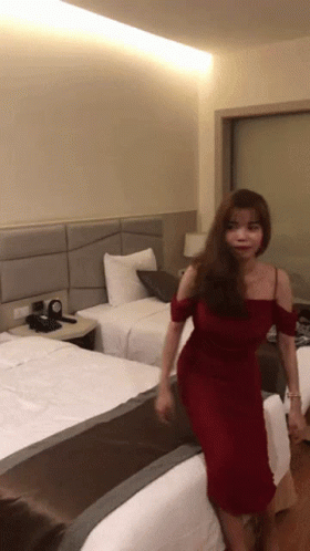 Woman In Red Dress In Hotel Room GIF