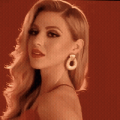 Woman In Red Dress Looking At Camera GIF