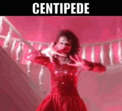 Woman In Red Dress Making Hand Gesture On Stairs GIF