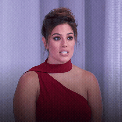 Woman In Red Dress Making Silly Face GIF