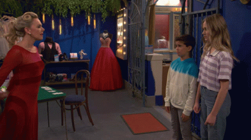 Woman in Red Dress Next to Boy in Blue and White Shirt