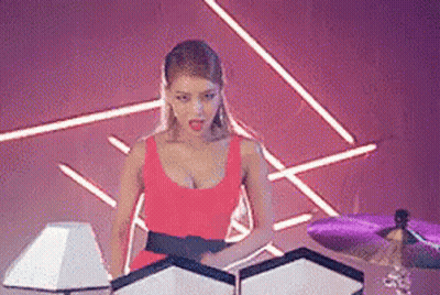 Woman in Red Dress Next to Drum Set