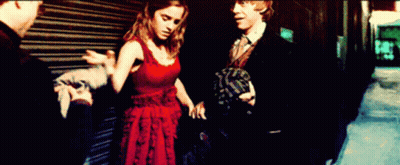 Woman In Red Dress Next To Man In Suit GIF