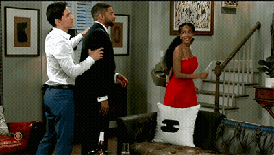 Woman In Red Dress Next To Man In Suit GIF