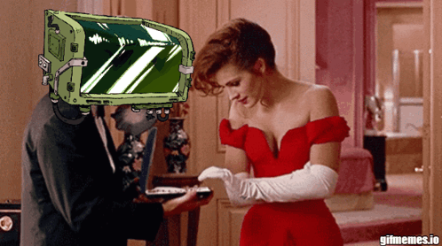Woman In Red Dress Next To Man With Green Box Saying Gifmemes.io GIF