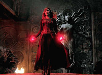 Woman In Red Dress Next To Statue GIF