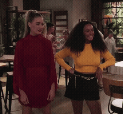 Woman In Red Dress Next To Woman In Yellow Shirt GIF