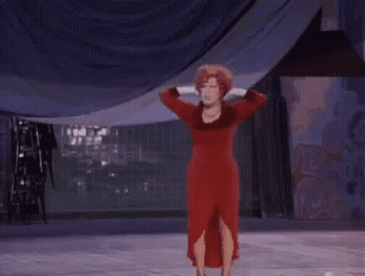 Woman In Red Dress On Stage Hands On Head GIF
