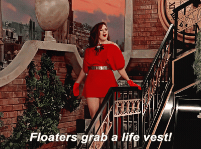 Woman In Red Dress On Stairs Saying Floaters Grab A Life Vest GIF