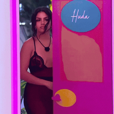 Woman In Red Dress Peeking From Pink Door GIF