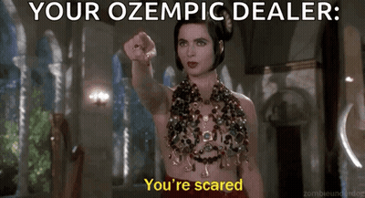 Woman In Red Dress Pointing At Camera Saying Your Ozempic Dealer You're Scared GIF