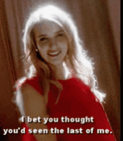 Woman In Red Dress Says I Bet You Thought You'd Seen The Last Of Me GIF